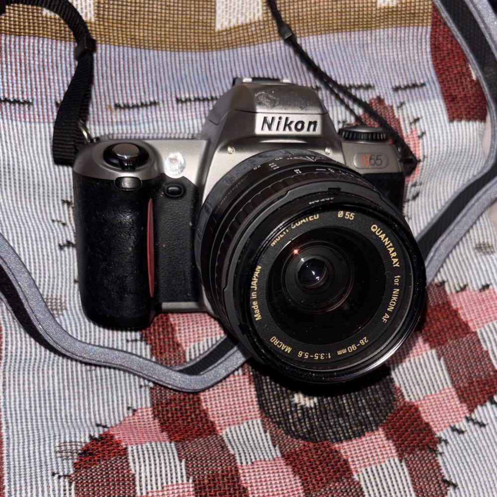 Nikon Silver and Black DSLR with Zoom Lens and Strap